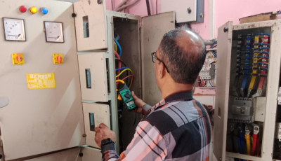 Electrical safety audit expert checking industrial control panel and cables for hazards