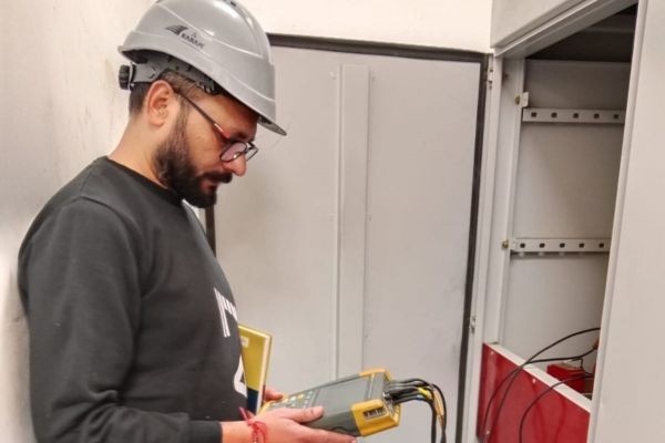 Home Energy audit expert performing electrical inspection in industrial control panel